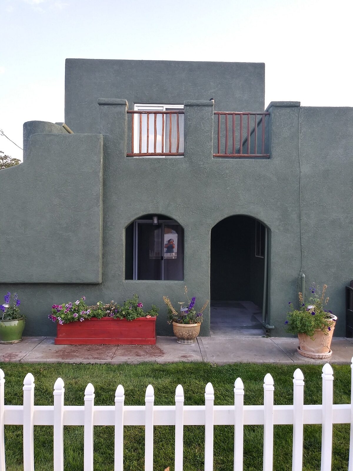 Two-story stucco home painted by Aragon's PRO Painting in San Juan County, NM