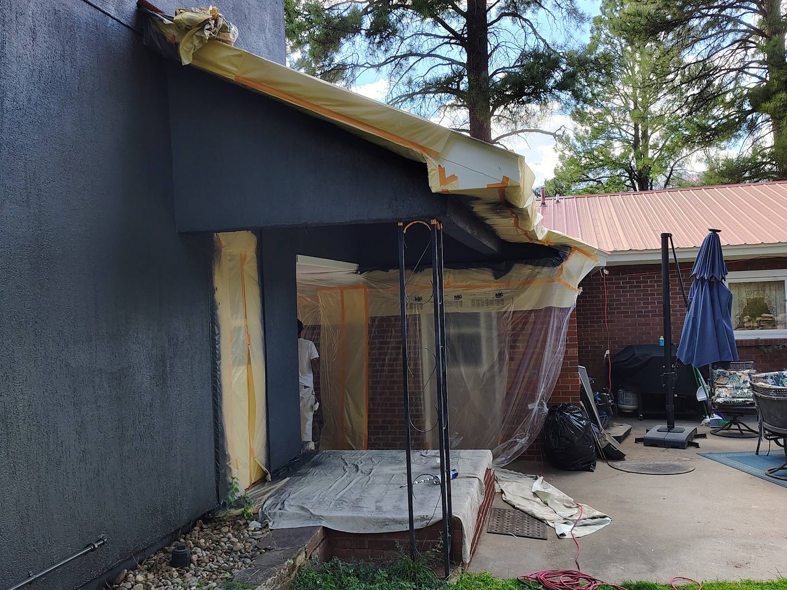 Charcoal exterior and patio on a repainted San Juan County cottage
