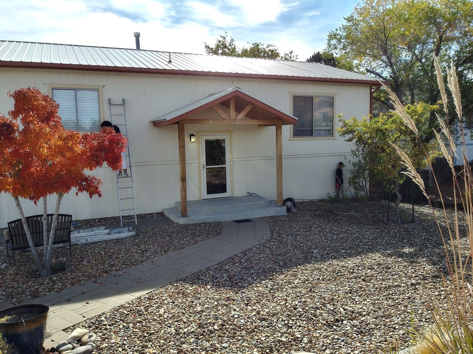 Home repainted with a new gabled porch entry on a fall day