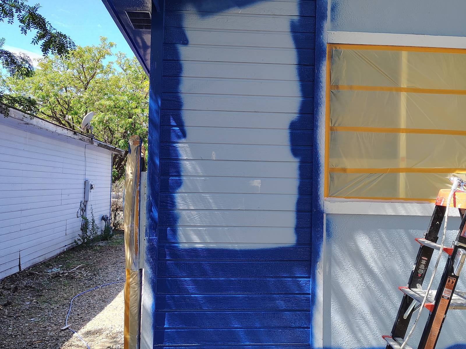 Windows masked off and the first blue coat going onto the siding